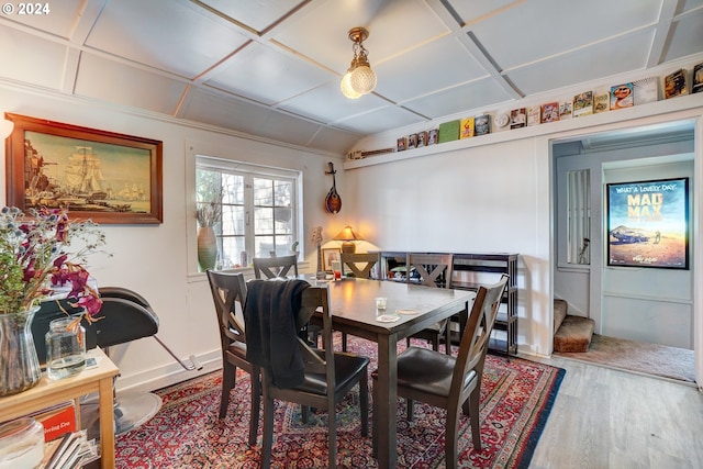 dining space with coffered ceiling and wood-type flooring