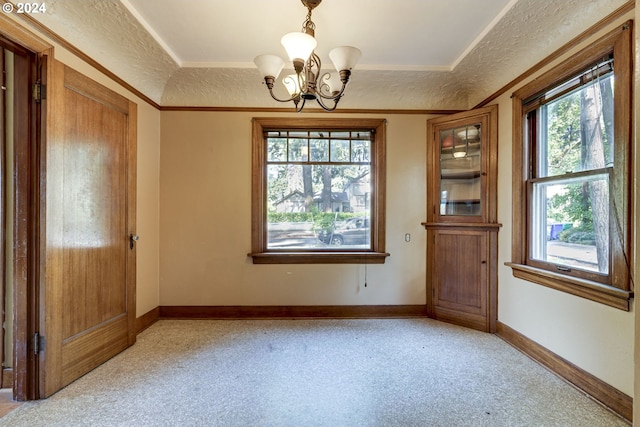 interior space featuring plenty of natural light, light colored carpet, a textured ceiling, and an inviting chandelier