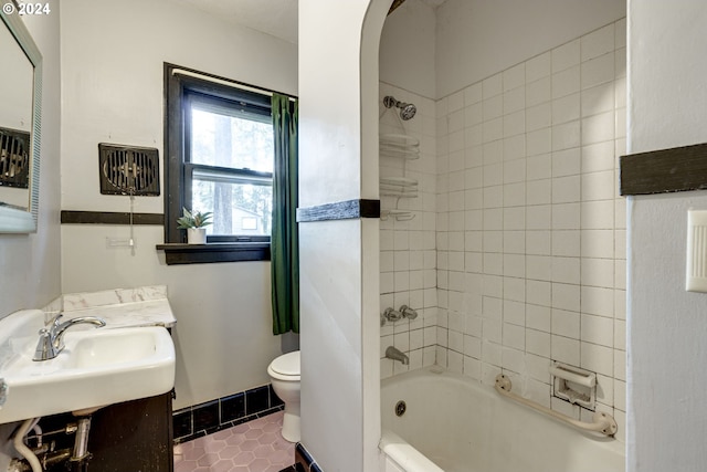 full bathroom featuring tile patterned floors, vanity, toilet, and tiled shower / bath