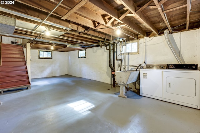 basement with separate washer and dryer and sink