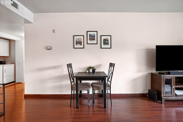 dining area featuring dark hardwood / wood-style floors and washer and dryer