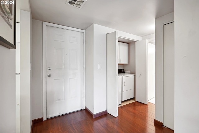 interior space featuring dark wood-type flooring and independent washer and dryer