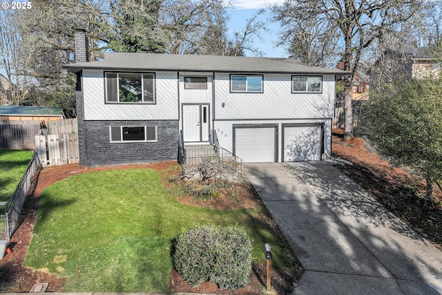 bi-level home with a garage and a front lawn