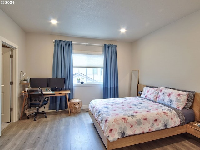 bedroom with hardwood / wood-style flooring