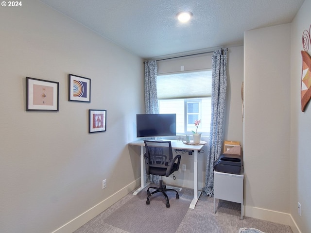 carpeted home office with a textured ceiling