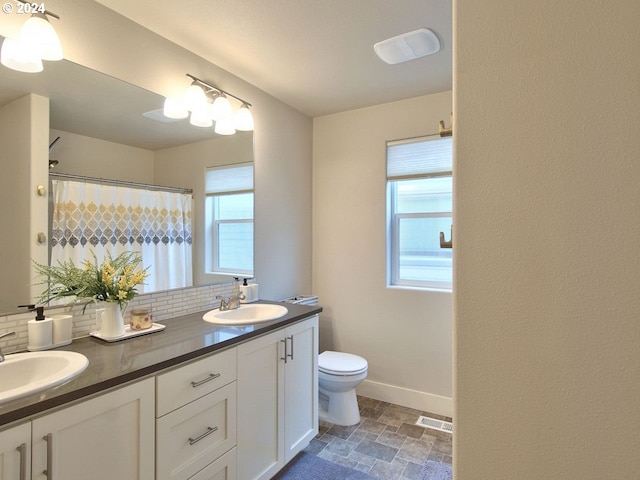 bathroom with curtained shower, vanity, toilet, and tasteful backsplash