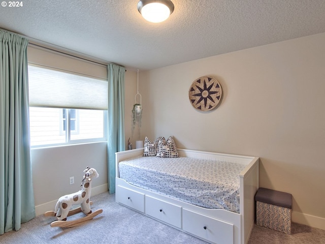 carpeted bedroom with a textured ceiling