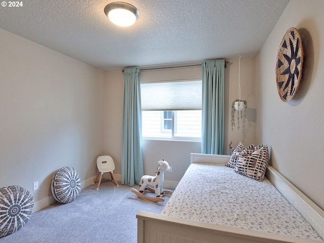 bedroom with a textured ceiling and carpet flooring