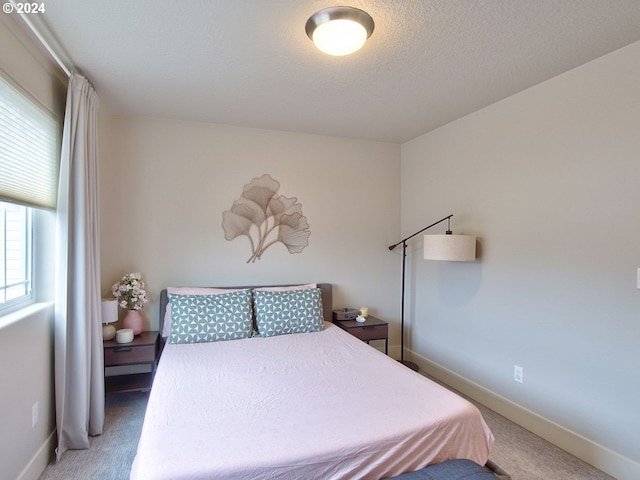 bedroom with carpet and a textured ceiling