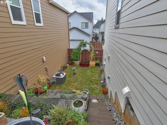 view of home's exterior featuring central AC unit and a yard