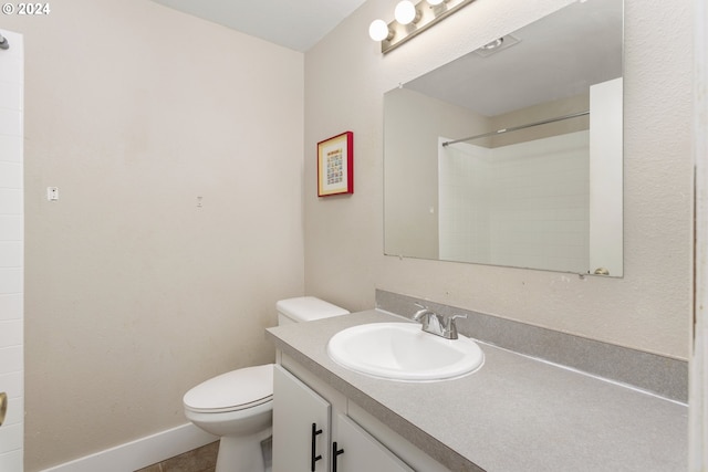 bathroom with a shower, vanity, and toilet