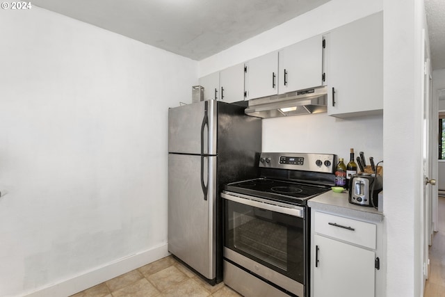 kitchen with white cabinetry, light tile patterned floors, and stainless steel appliances