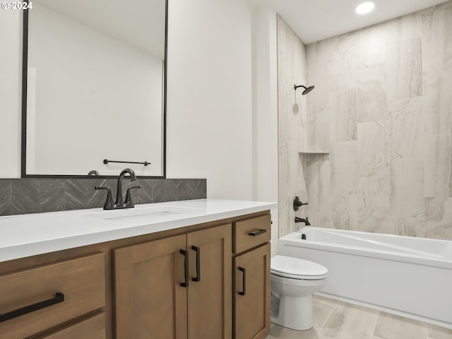 full bathroom featuring tile patterned flooring, backsplash, toilet, vanity, and tiled shower / bath