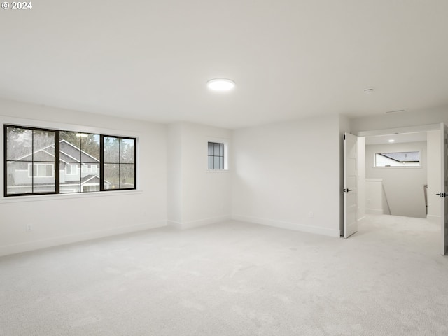 basement featuring light carpet