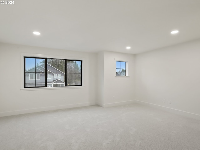 empty room with plenty of natural light and carpet