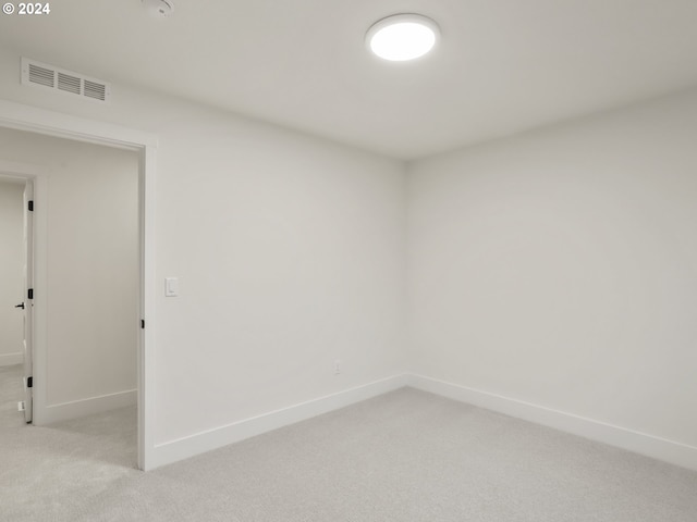 spare room featuring light colored carpet