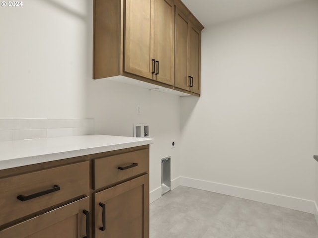 clothes washing area featuring electric dryer hookup, cabinets, and washer hookup