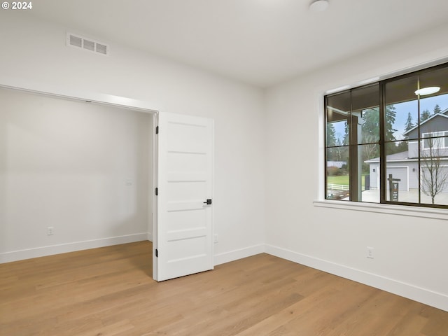 unfurnished room featuring light wood-type flooring