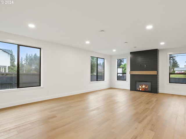 unfurnished living room featuring light hardwood / wood-style floors and a fireplace