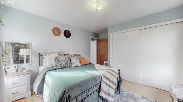 bedroom with light wood-type flooring and a closet