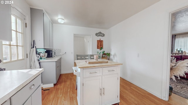 kitchen with light wood-type flooring and white cabinetry