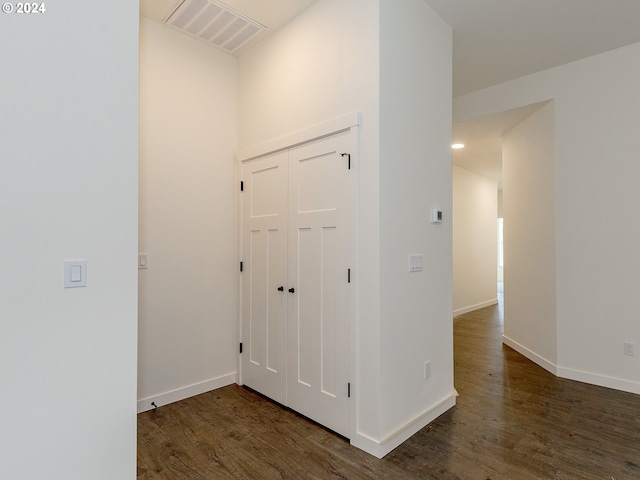 hallway with dark hardwood / wood-style flooring