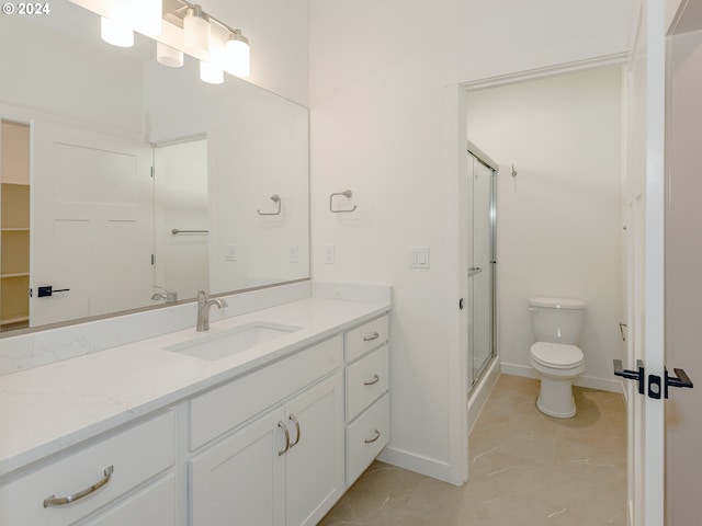 bathroom featuring vanity, toilet, and walk in shower