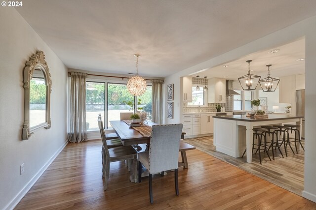 dining room featuring an inviting chandelier and light hardwood / wood-style floors