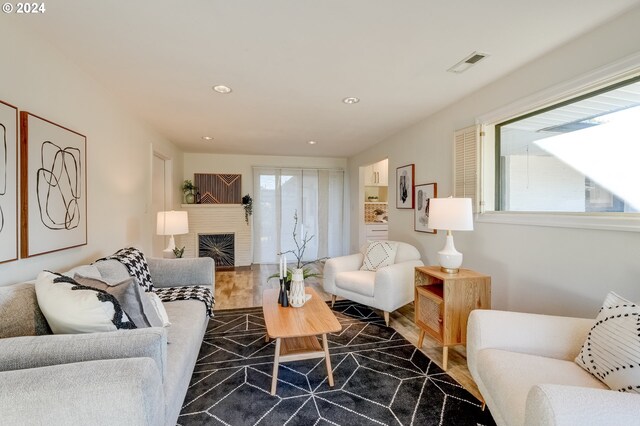 living room featuring a fireplace and plenty of natural light