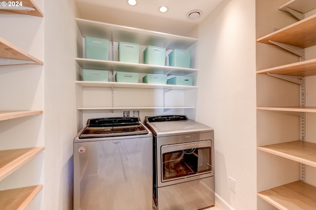 clothes washing area featuring washer and clothes dryer