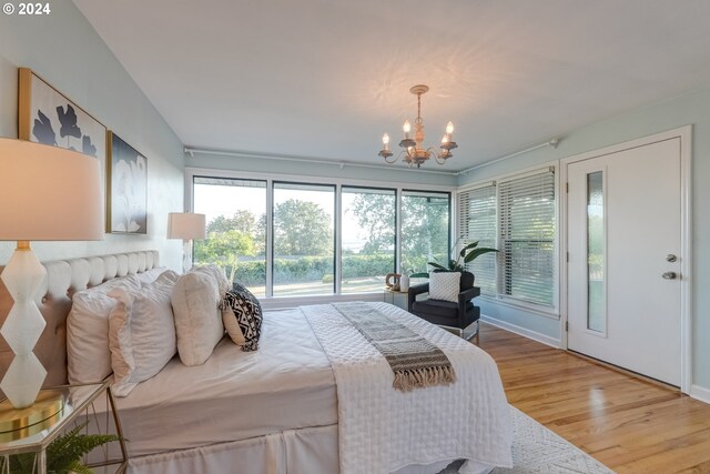 bedroom featuring light hardwood / wood-style flooring and a chandelier