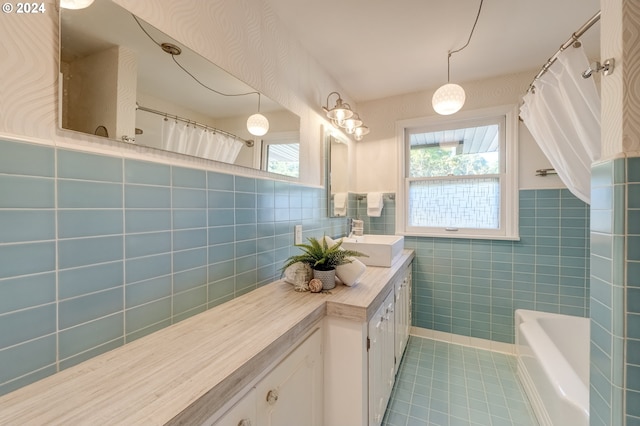 bathroom featuring tile patterned floors, vanity, backsplash, and tile walls