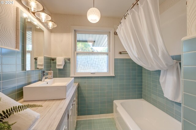 bathroom featuring tile walls, tile patterned flooring, decorative backsplash, and vanity