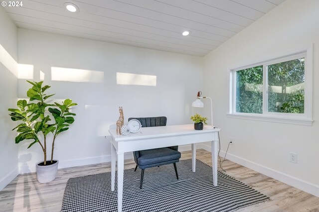 office space with wood-type flooring and vaulted ceiling