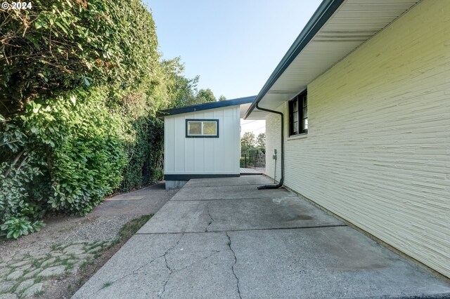 view of side of home with a patio