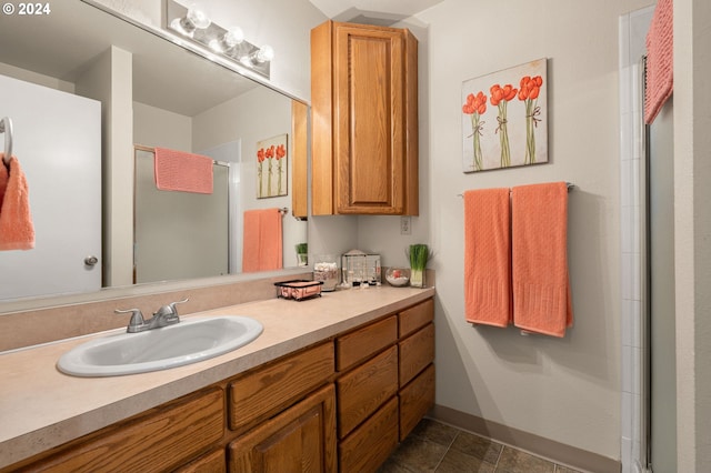 bathroom with vanity, tile patterned floors, and a shower with door