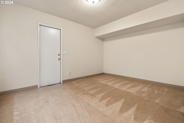 carpeted spare room featuring a textured ceiling