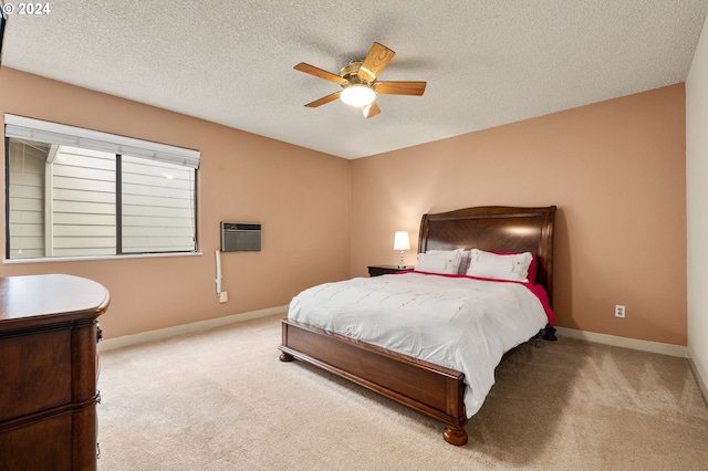 carpeted bedroom featuring an AC wall unit, a textured ceiling, and ceiling fan