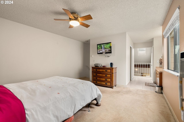 carpeted bedroom with a textured ceiling and ceiling fan