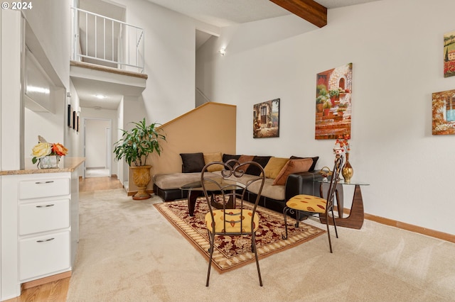 carpeted living room with vaulted ceiling with beams