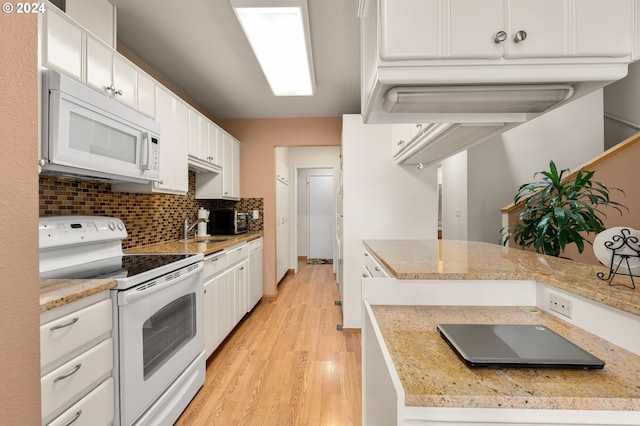 kitchen with decorative backsplash, light hardwood / wood-style floors, sink, white cabinets, and white appliances