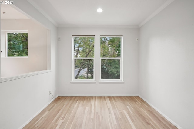 spare room with light hardwood / wood-style floors and ornamental molding