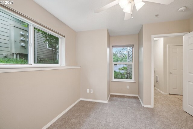 unfurnished bedroom with ceiling fan and light carpet