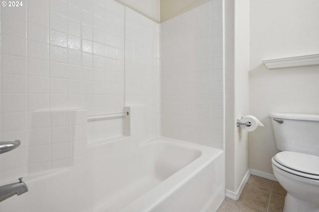 bathroom with tile patterned floors, shower / washtub combination, and toilet