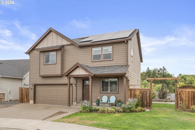 craftsman-style house featuring a garage, a front yard, and solar panels