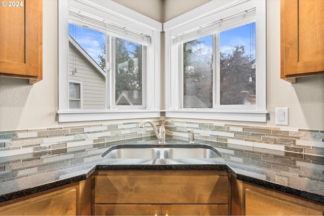 kitchen with sink and dark stone counters