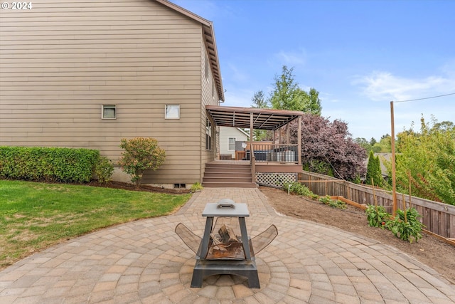 view of patio featuring a deck and an outdoor fire pit