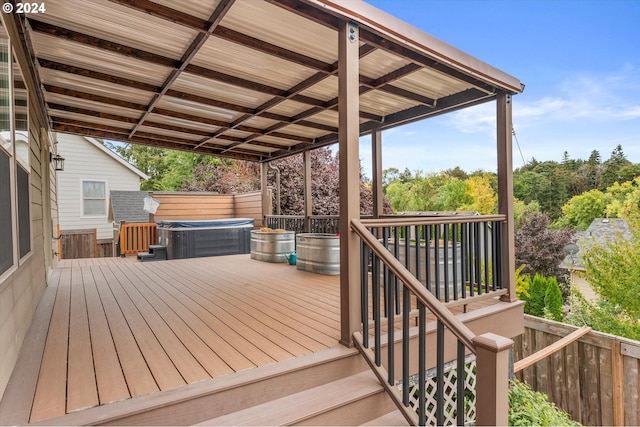 wooden deck with a hot tub