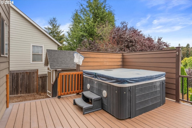 wooden deck featuring a hot tub