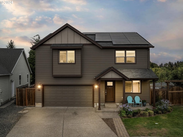 view of front of house featuring solar panels, a garage, and a patio